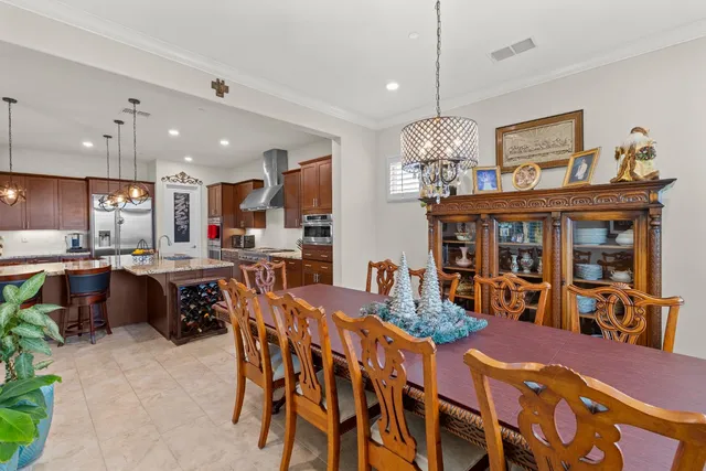 a view of a dining room with furniture kitchen and chandelier