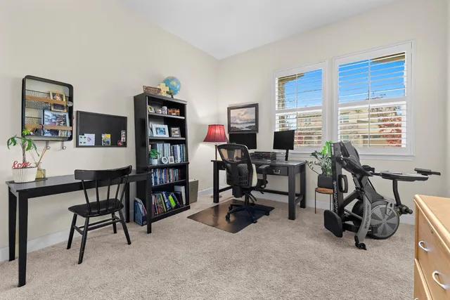 a view of a workspace with furniture and a bookshelf