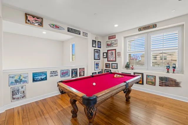 a room with pool table and windows