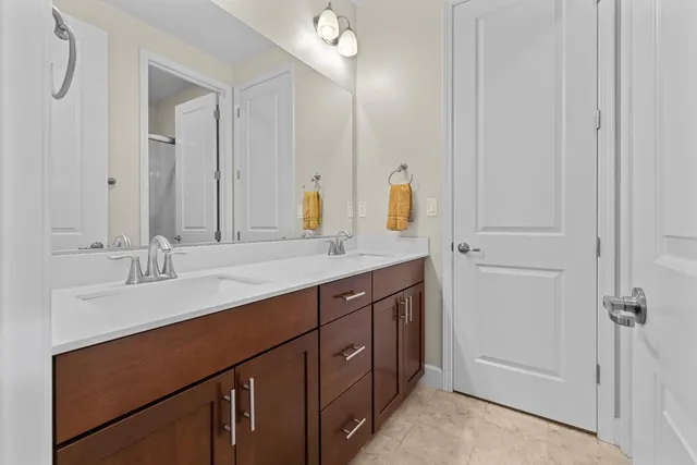 a bathroom with a double vanity sink a and mirror