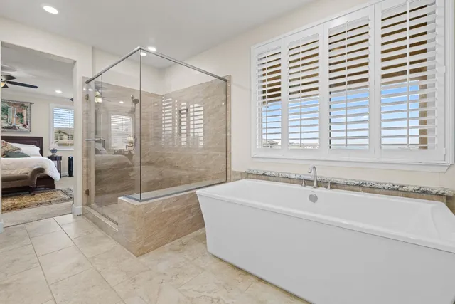 a spacious bathroom with a tub and a shower