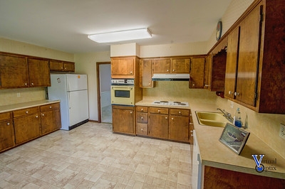 1497 Tinkling Spring Road Staunton, VA 24401 - Photo 10 of 31 a kitchen with a sink stove and refrigerator