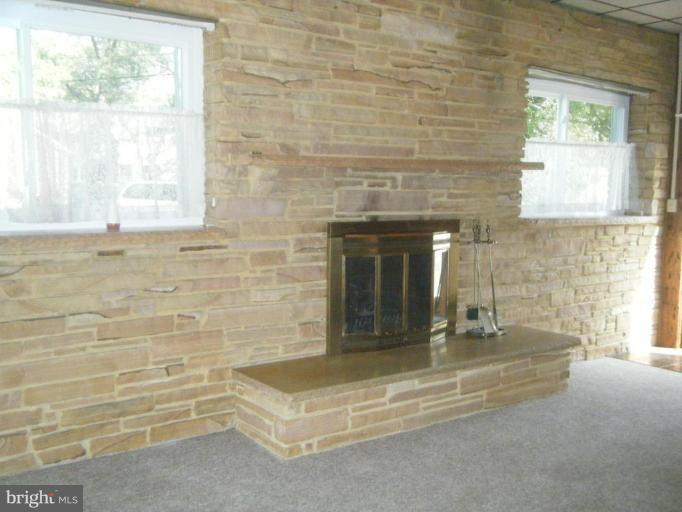 8426 Bay Road Pasadena, MD 21122 - Photo 5 of 16 Family room with stone fireplace