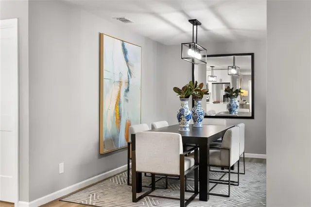 a dining room with furniture a chandelier and window