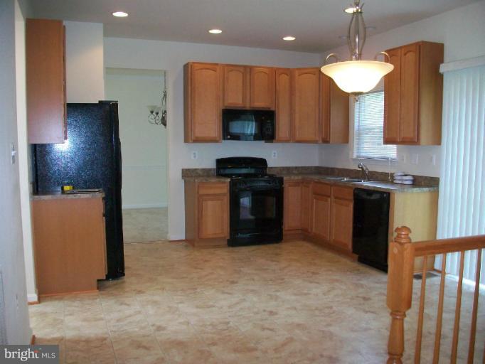 8705 Francesca Drive Clinton, MD 20735 - Photo 1 of 25 a kitchen with stainless steel appliances granite countertop a stove a sink and a refrigerator