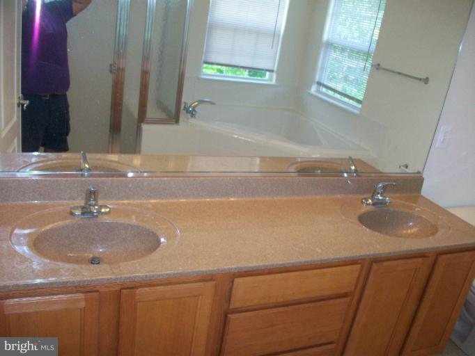 8705 Francesca Drive Clinton, MD 20735 - Photo 16 of 25 a bathroom with a sink and a mirror
