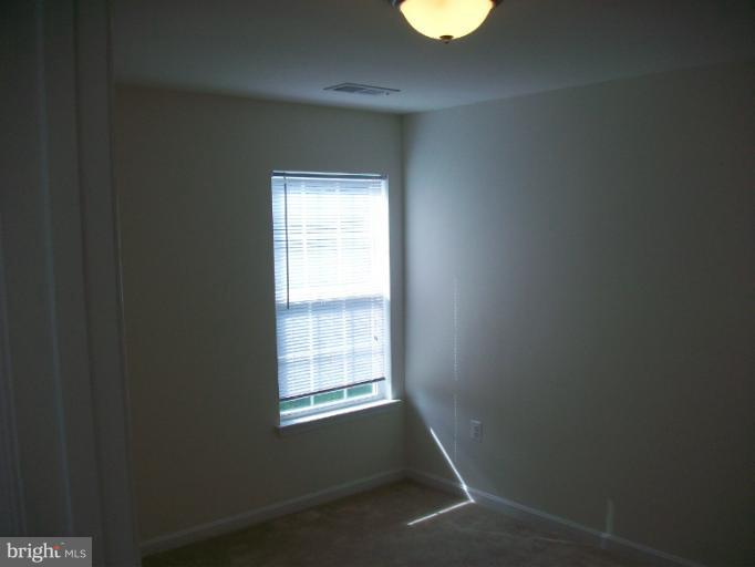 8705 Francesca Drive Clinton, MD 20735 - Photo 17 of 25 a view of an empty room with a window