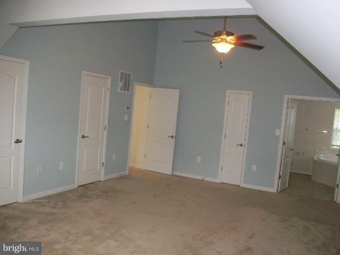 8705 Francesca Drive Clinton, MD 20735 - Photo 24 of 25 a view of an empty room with a chandelier fan