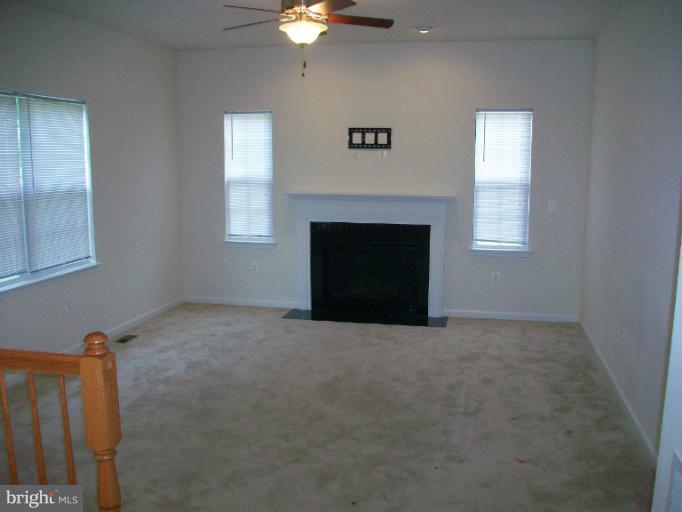 8705 Francesca Drive Clinton, MD 20735 - Photo 4 of 25 an empty room with windows and fireplace