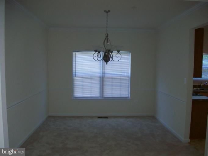 8705 Francesca Drive Clinton, MD 20735 - Photo 7 of 25 a view of a room with a ceiling fan and a window