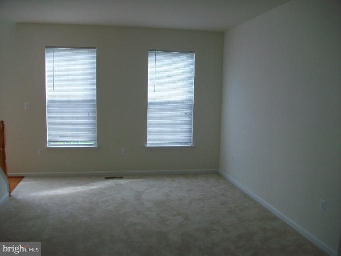 8705 Francesca Drive Clinton, MD 20735 - Photo 10 of 25 an empty room with windows