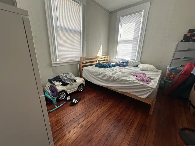 a bed sitting in a bedroom next to a window