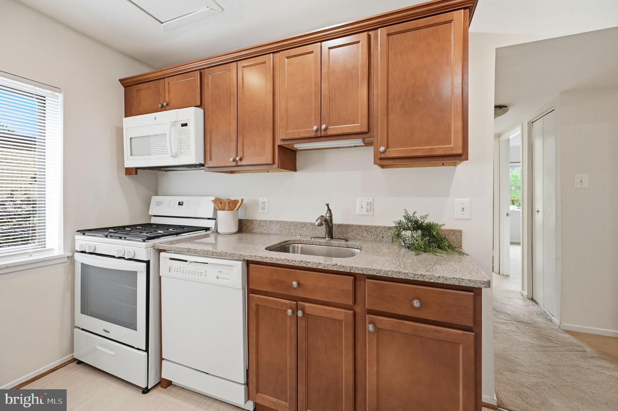 1659 Parkcrest Circle, Unit C Reston, VA 20190 - Photo 20 of 31 a kitchen with stainless steel appliances granite countertop a sink stove and cabinets