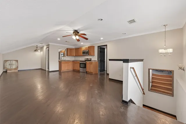 a view of a kitchen with a sink a refrigerator and a stove top oven