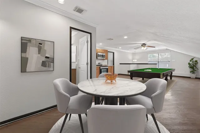 a view of a dining room with furniture and wooden floor