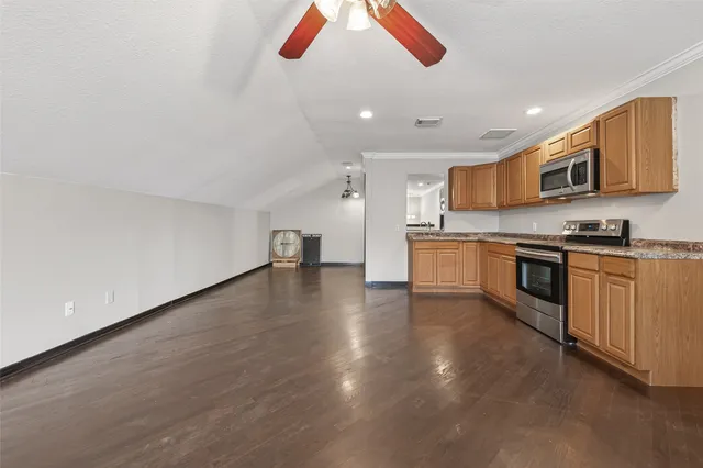 a kitchen with stainless steel appliances granite countertop a stove and a sink