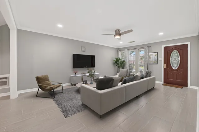 a living room with furniture and a large window