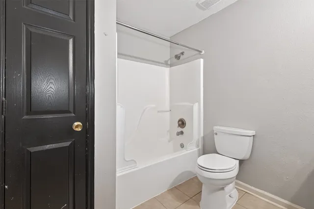 a bathroom with a toilet and shower