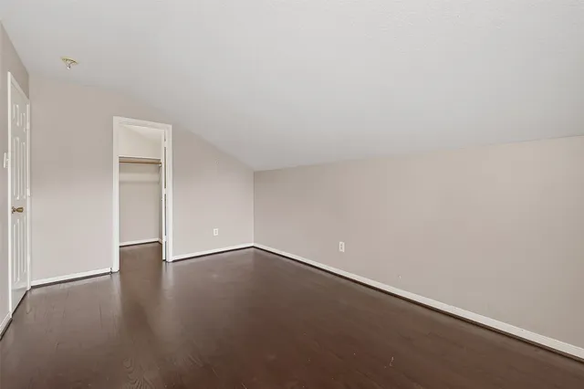 a view of an empty room and wooden floor