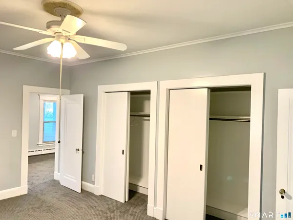 a view of an empty room with a ceiling fan