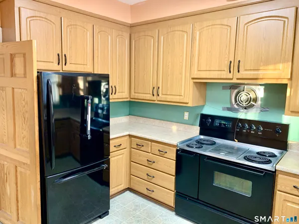 a kitchen with stainless steel appliances granite countertop a refrigerator stove and cabinets