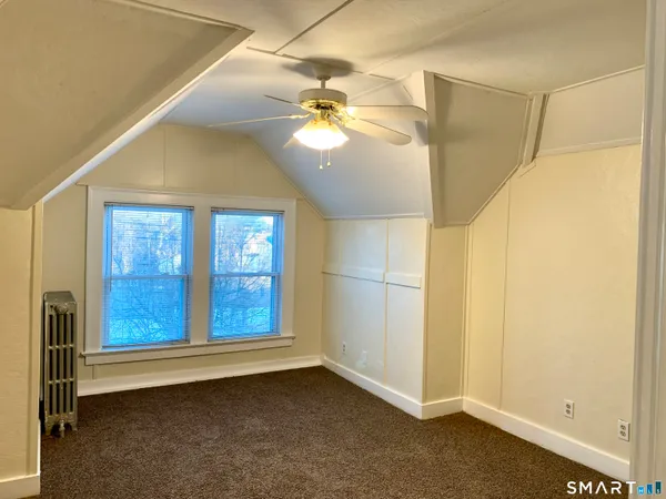 a view of a room with window and ceiling fan