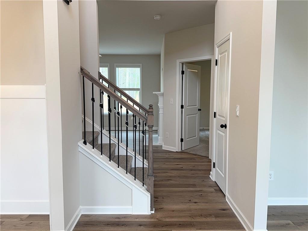 345 Rodeo Drive Auburn, GA 30011 - Photo 2 of 22 a view of a hallway with wooden floor and staircase
