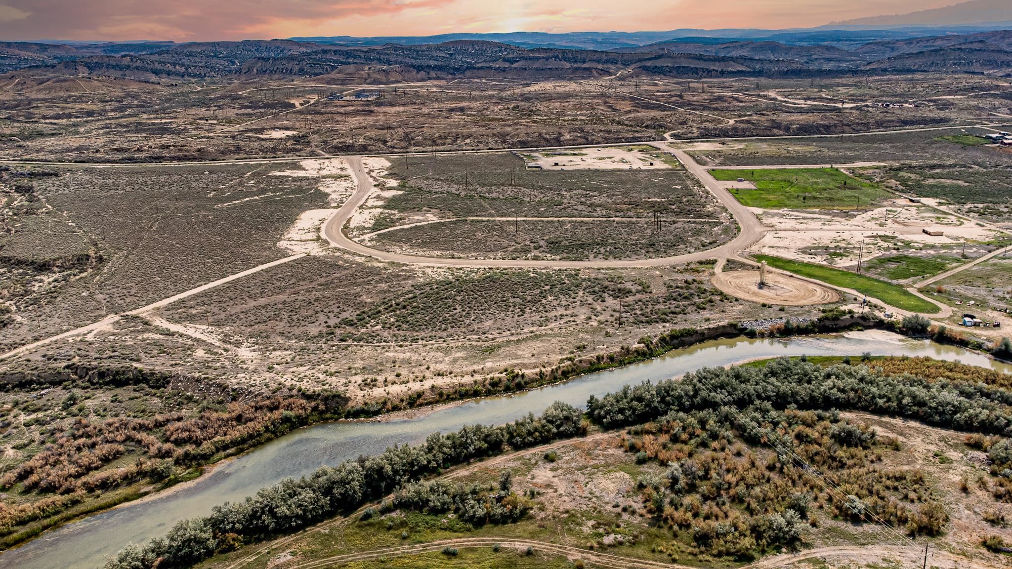 416 Rio Mesa Drive Rangely, CO 81648 - Photo 1 of 6 a view of a lake with a mountain