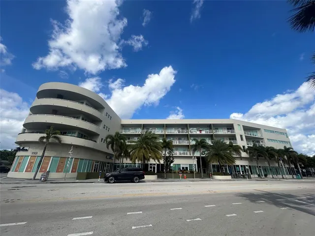 a kitchen with sink cabinets and living room view