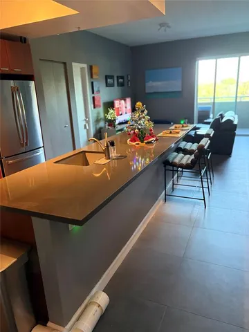 a kitchen with stainless steel appliances kitchen island granite countertop a stove and cabinets