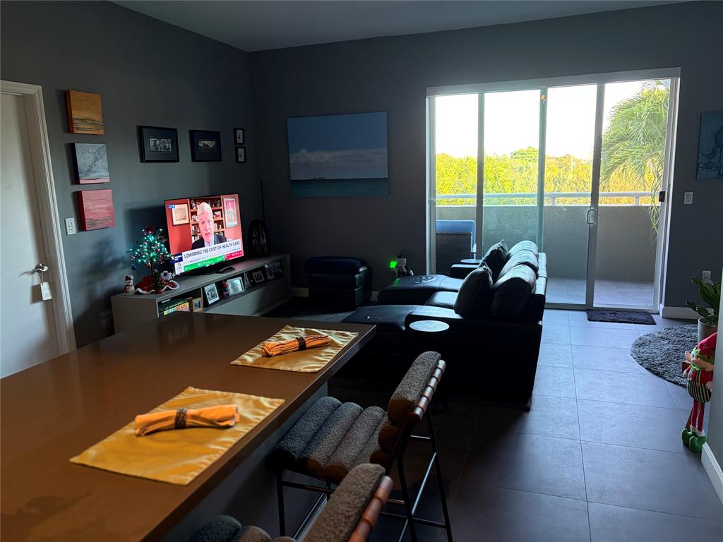 2301 Wilton Drive, Unit R309 Wilton Manors, FL 33305 - Photo 13 of 26 a living room with furniture and a flat screen tv