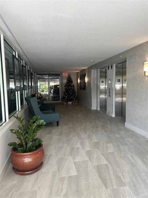 2301 Wilton Drive, Unit R309 Wilton Manors, FL 33305 - Photo 20 of 26 a lobby with furniture and potted plants