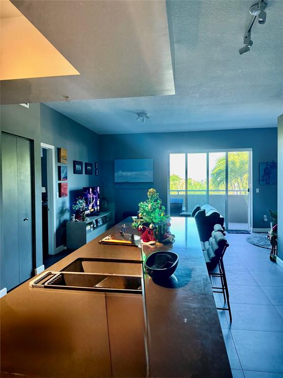 2301 Wilton Drive, Unit R309 Wilton Manors, FL 33305 - Photo 3 of 26 a room with furniture and a large window