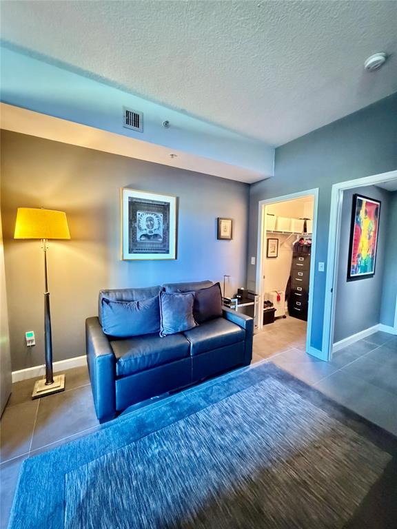 2301 Wilton Drive, Unit R309 Wilton Manors, FL 33305 - Photo 5 of 26 a living room with furniture and a wooden floor