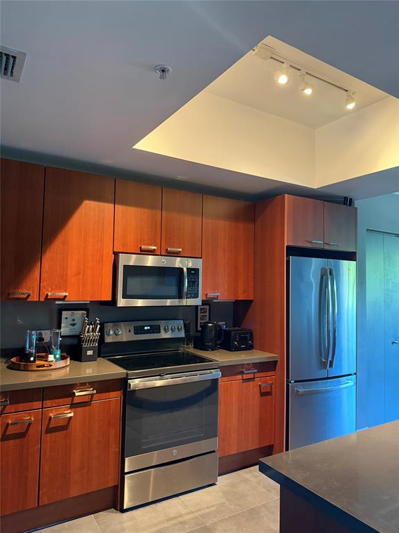 2301 Wilton Drive, Unit R309 Wilton Manors, FL 33305 - Photo 8 of 26 a kitchen with stainless steel appliances a stove a sink and a microwave