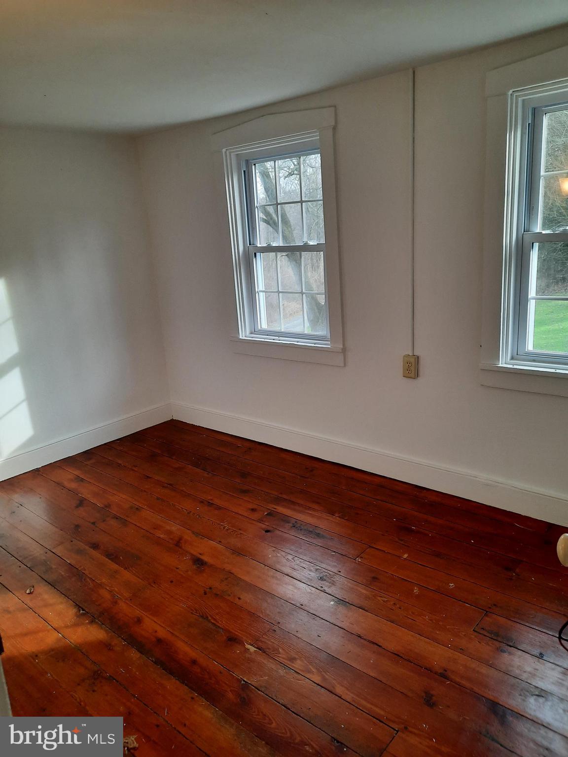 1515 River Road Drumore, PA 17518 - Photo 11 of 13 a view of empty room with wooden floor and fan