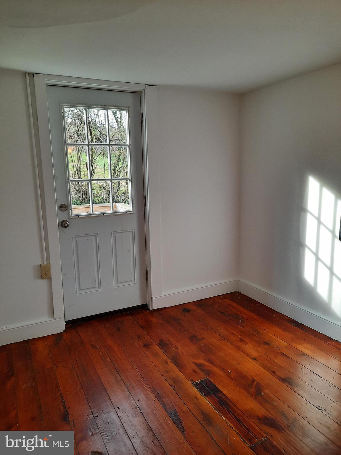 1515 River Road Drumore, PA 17518 - Photo 9 of 13 an empty room with wooden floor and windows