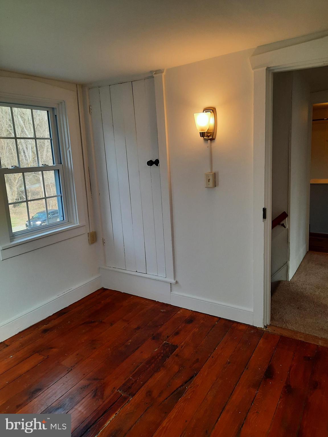1515 River Road Drumore, PA 17518 - Photo 10 of 13 an empty room with wooden floor and windows