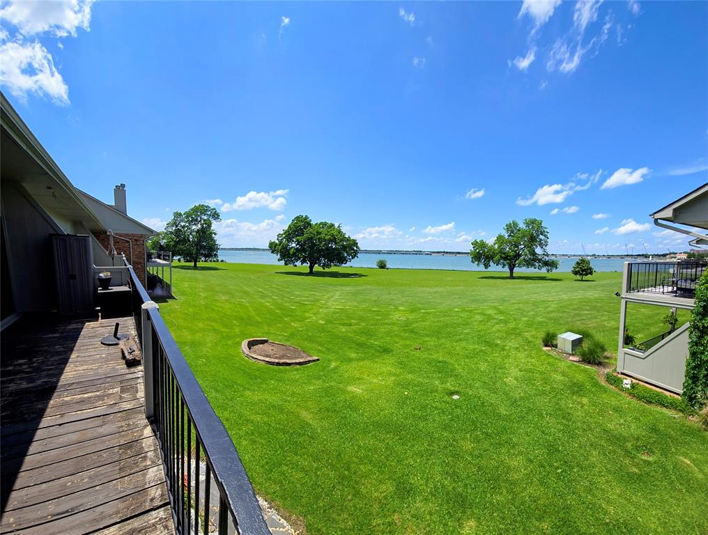 1904 Signal Ridge Place Rockwall, TX 75032 - Photo 3 of 23 Expansive waterfront lawn with mature trees and a tranquil water backdrop