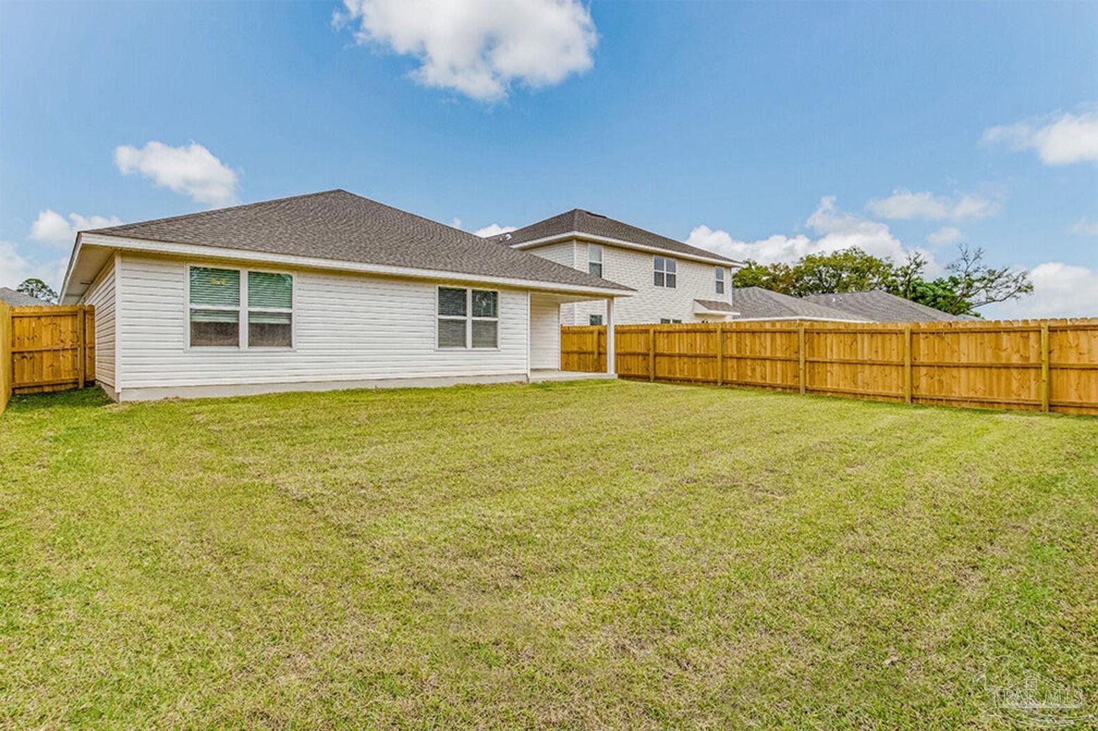 265 Monarch Lane Pensacola, FL 32503 - Photo 12 of 13 a view of a house next to a yard with an outdoor seating