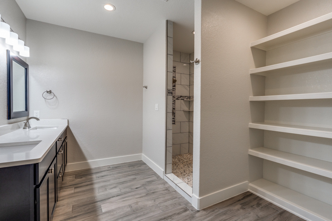 1848 Tanglewood Trail Spring Branch, TX 78070 - Photo 12 of 12 A well-appointed bathroom features a spacious vanity with dual sinks, a walk-in shower, and generous built-in shelving.