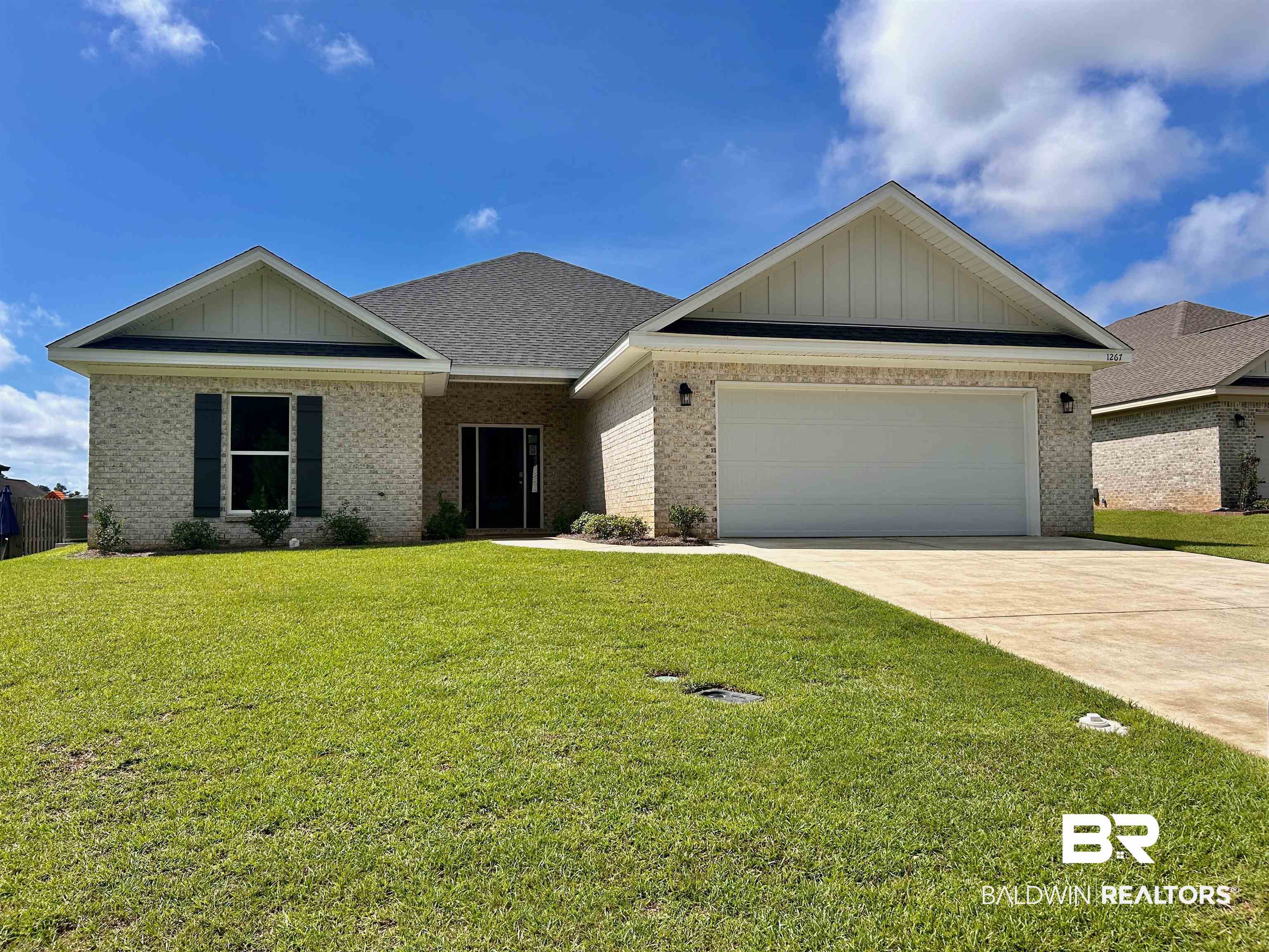 1267 Pembroke Way Foley, AL 36535 - Photo 1 of 17 View of front of house with a garage and a front lawn