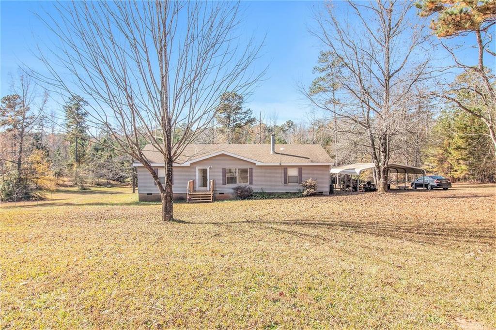 3573 Jonathans Roost Road Williamson, GA 30292 - Photo 1 of 1 a yellow house that has a tree in it
