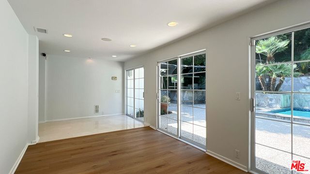 a view of a backyard with wooden fence