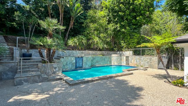 a view of a wooden deck and a backyard