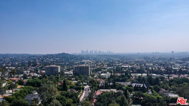 an aerial view of a house with a yard and garden