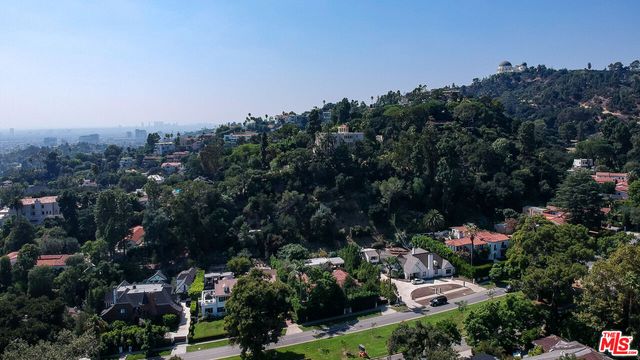 a bathroom with a granite countertop sink mirror bathtub and toilet