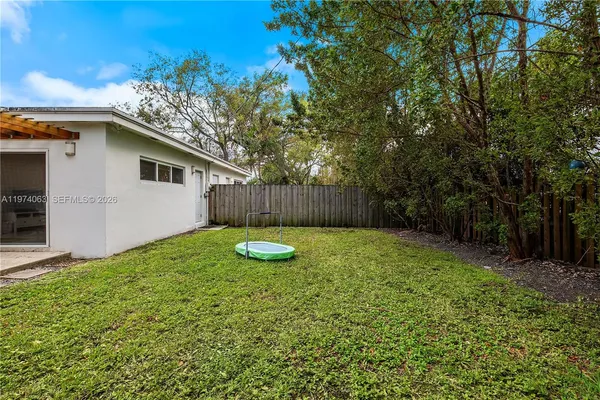 a view of a backyard with a tree