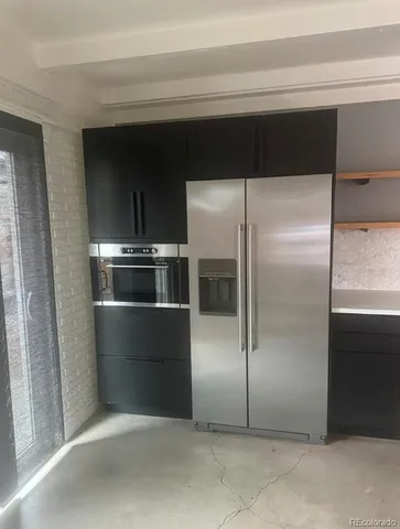 a kitchen with a refrigerator and a refrigerator