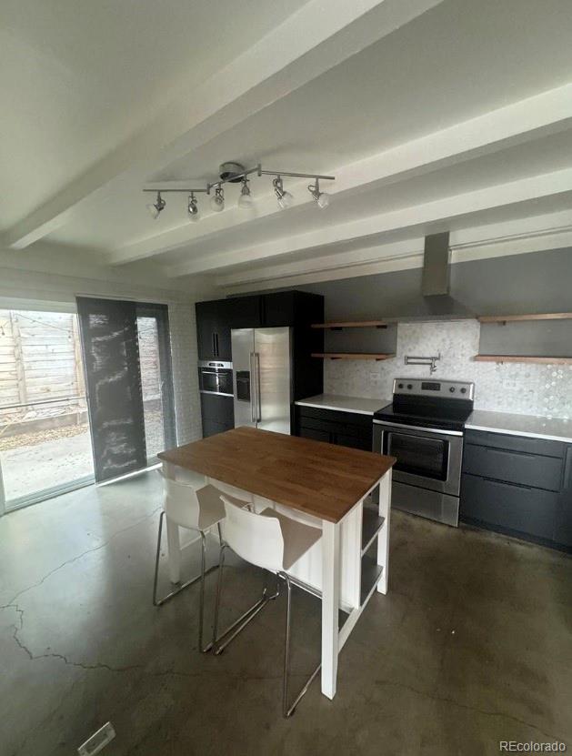 1040 Stuart Street Denver, CO 80204 - Photo 4 of 9 a kitchen with a table chairs sink and cabinets